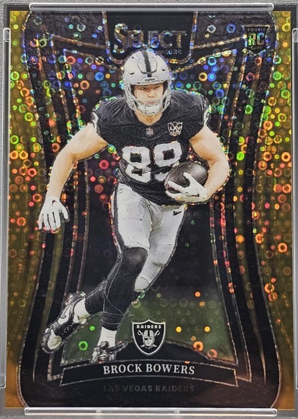 Actual public catalogue photograph of Brock Bowers 2024 Panini Select Suite Level #383 Gold Disco Prizm rookie card, with a gold border and circular foil pattern. The serial of this reference copy is not visible. The requested card is 07/10.