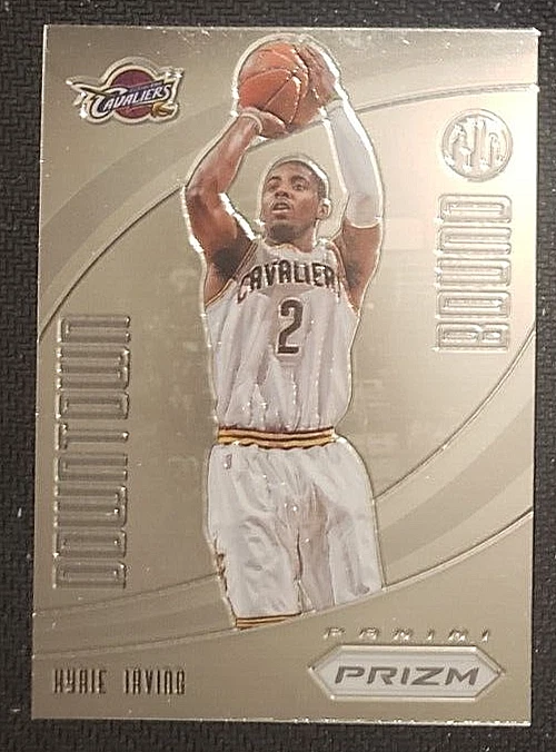 Independent reference photo of Kyrie Irving 2012–13 Panini Prizm Downtown Bound #13, showing him shooting in a white Cavaliers uniform. This is a different physical card.