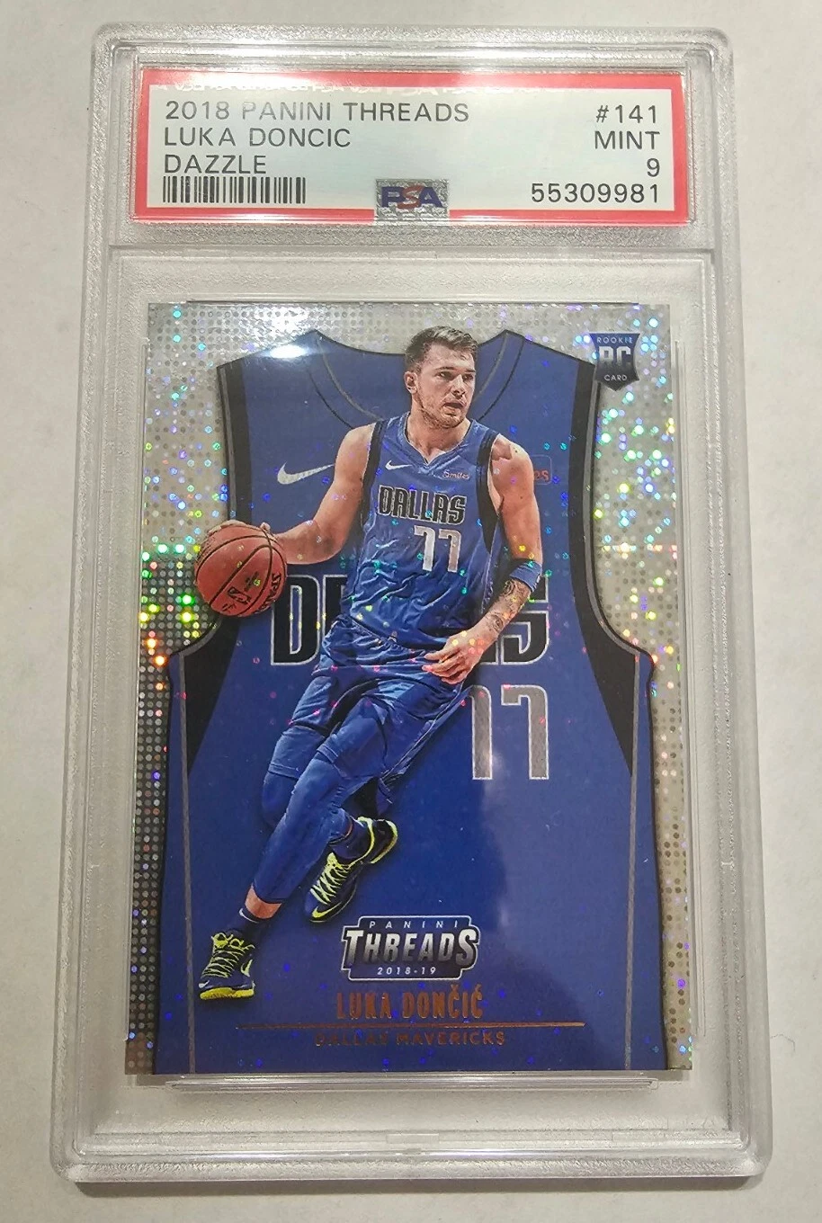 Luka Dončić 2018 Panini Threads #141 Dazzle in a PSA 9 slab, photographed certification 55309981, blue Icon Jersey design.