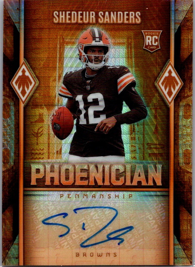 Actual independent photograph of Shedeur Sanders 2025 Phoenix Phoenician Penmanship Hyper autograph, with a Cleveland Browns rookie design and blue signature on a sticker. The reference reverse reads 025/199; it is not the requested card.