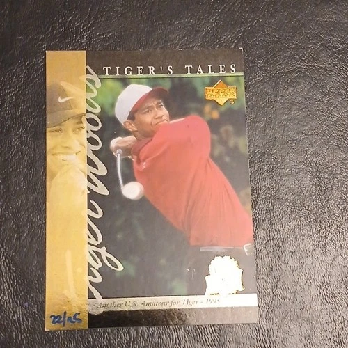 Independent seller reference of Tiger Woods Tiger's Tales TT10, the 2026 25th Anniversary stamped buyback of the 2001 card, hand-numbered 22/25. Tiger wears a red shirt; the commemorative stamp has glare. This is not an autograph.
